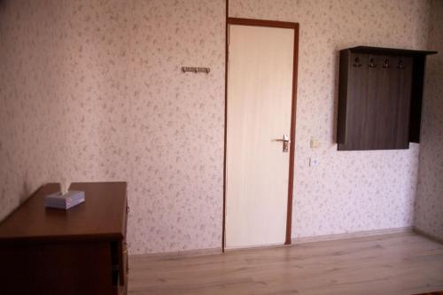 an empty room with a door and a wooden table at B&B Sunrise House Aygavan in Aygavan