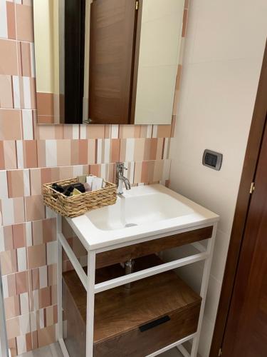 a bathroom with a sink and a mirror at B&B La DORMERIA in Finale Ligure