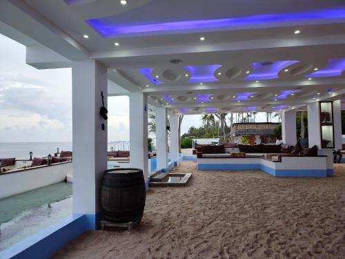 a large lobby with blue lights on a beach at Vee's Villa in Kilifi