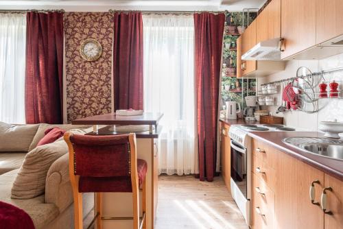 a kitchen with a couch and a table in a room at Videviku Villa Apartments in Tallinn