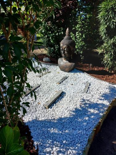 a statue sitting on top of a pile of gravel at Le Mill in Meilhan