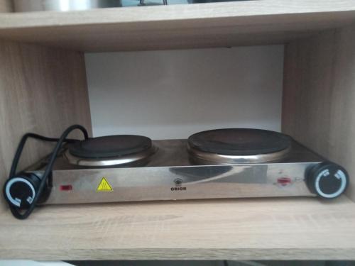 a toaster oven sitting on top of a shelf at Kiss-Szőllősi Vendégház II-RAMI in Debrecen