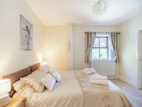 a bedroom with a large bed with two pillows on it at Squirrel Cottage - Uk37886 in Stanhope