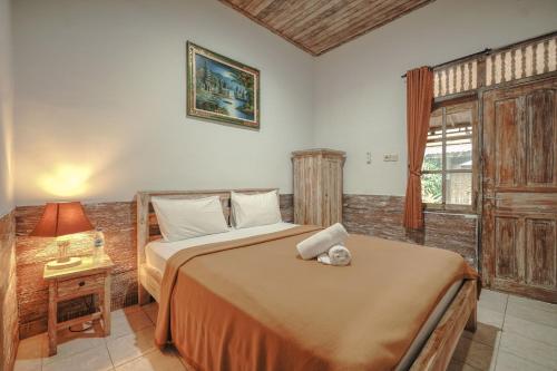 Postel nebo postele na pokoji v ubytování Krisna Homestay