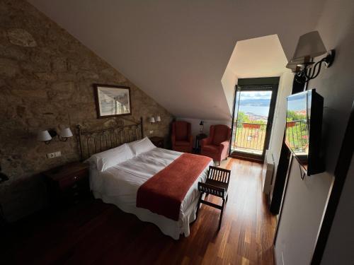 Postel nebo postele na pokoji v ubytování Hotel Rústico Finisterrae