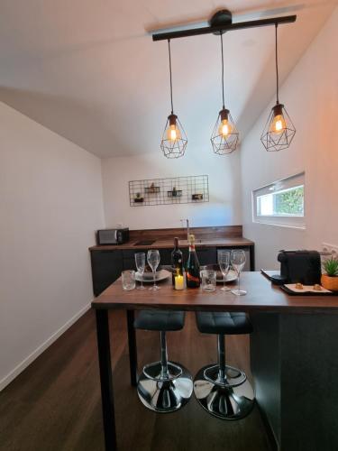 a kitchen with a table with wine glasses on it at Chalet privatif / suite romantique love balneo in Le Castellet