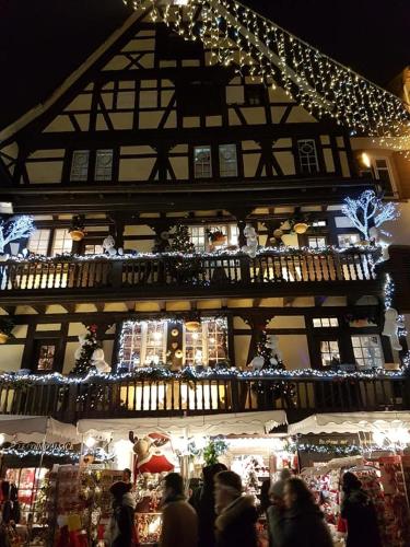 a group of people walking around a christmas market at gite joseph 2pers dans le vignoble à 8km de Colmar in Ammerschwihr