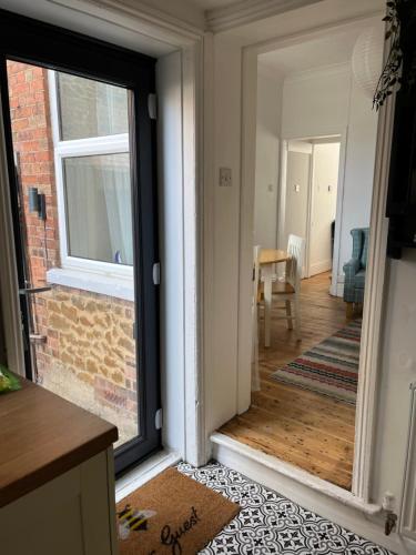 a kitchen with a sliding glass door with a dining room at Avocet House Hunstanton 250m from the sea in Hunstanton