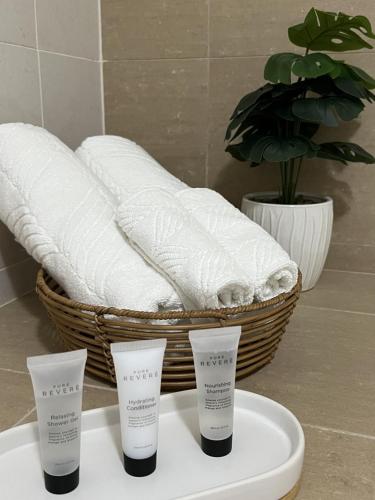 a basket of towels and two cups on a table at 2 bedroom modern coastal retreat in Kiama
