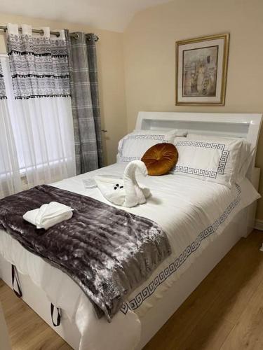 a bedroom with a bed with a swan on it at Gated home close to Birmingham City Centre in Birmingham