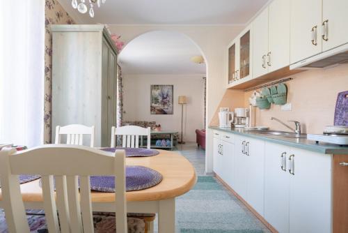 a kitchen with a table and chairs in a room at Videviku Villa Apartments in Tallinn