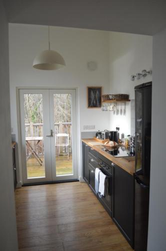 a kitchen with a sink and a stove top oven at mill house steading overlooking the sea and mull in Bonnavoulin