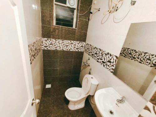 a bathroom with a toilet and a sink at Siolim 6bhk Private Villa with Private Pool close to Anjuna Vagator in Siolim