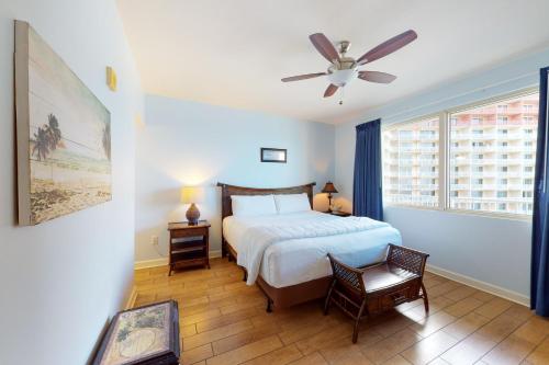 a bedroom with a bed and a ceiling fan at Shores of Panama 1615 in Panama City Beach