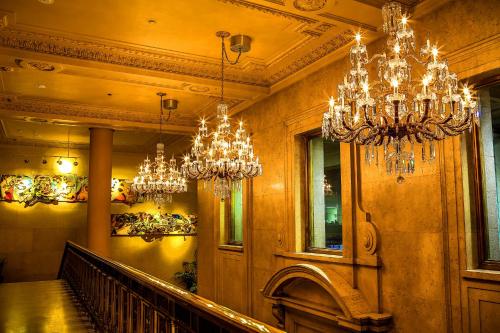 a hallway with chandeliers and a staircase in a building at One King West Hotel and Residence in Toronto