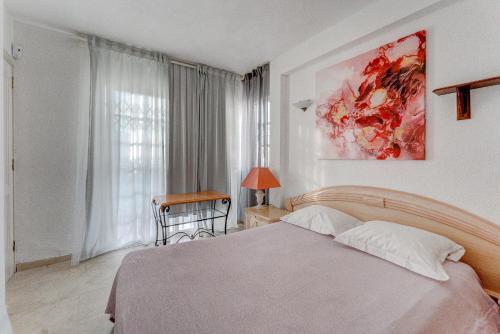 a bedroom with a bed and a painting on the wall at Marvelous holiday home - villa La Caleta in Adeje