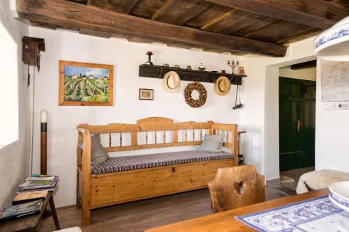 a bedroom with a wooden bed and a table at Kellerstöckl Am Weinberg 140 Gaas in Gaas