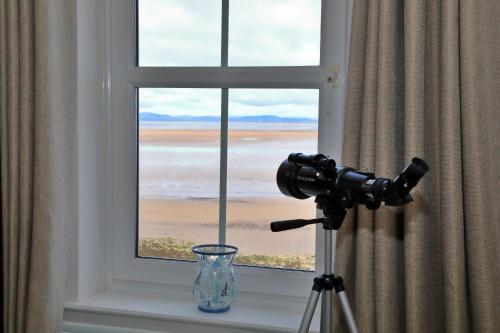a camera on a window sill with a view of the beach at Finest Retreats - Glendale in Skinburness
