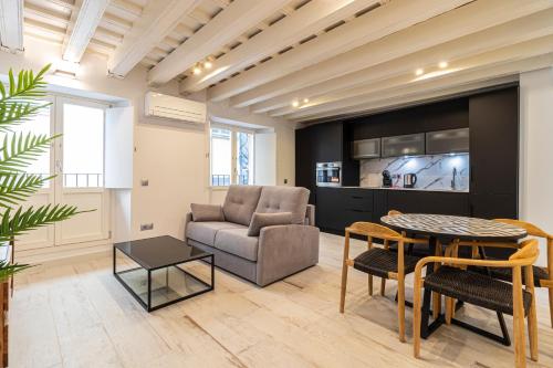 a living room with a couch and a table at Allo Apartments San Roque 1ºA in Cádiz