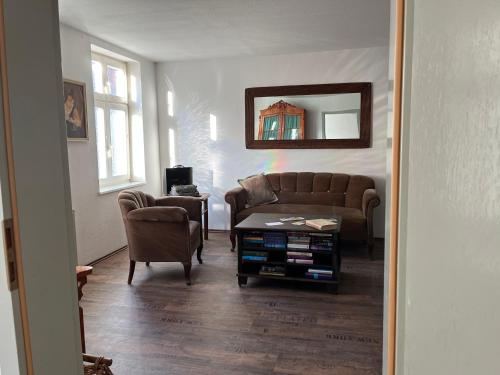 a living room with a couch and a table at Ferienwohnung Kaufmannshof in Quedlinburg
