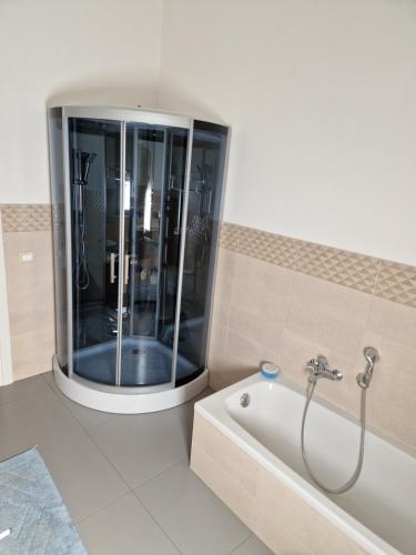 a bathroom with a shower and a tub in it at Pepe's house , a 1 km dal mare in Isca sullo Ionio