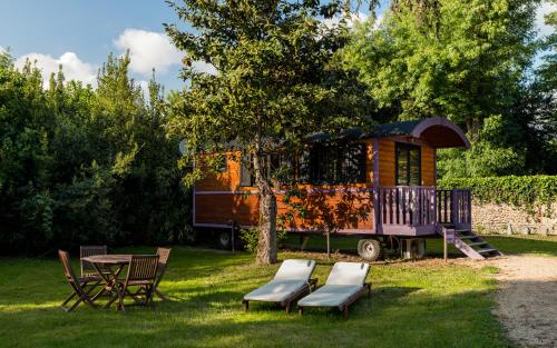 a tiny house with a table and chairs in a yard at Hôtel Quai des Pontis in Cognac