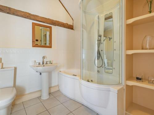 a bathroom with a shower and a tub and a sink at The Dairy - Uk37518 in Routh