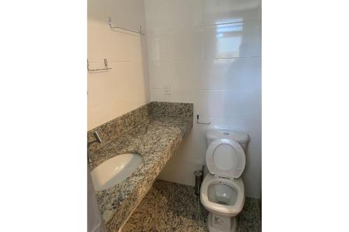 a bathroom with a toilet and a sink at Locking´s Santo Agostinho 5 - Apto 2 quartos 2 vagas novo in Belo Horizonte