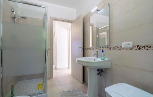 a bathroom with a sink and a shower and a mirror at Beautiful Home In Farindola With 2 Bedrooms in Farindola