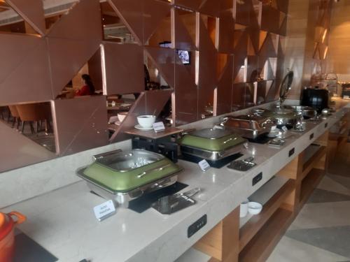 a kitchen with a counter with several pots and pans at Best Western Vrindavan in Vrindāvan