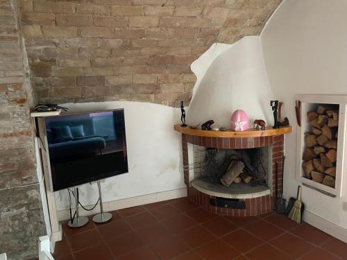 a living room with a tv and a fireplace at CASA CELOMMI in Montepagano