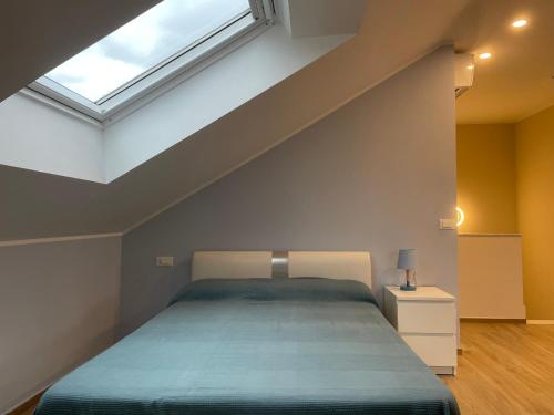 a bedroom with a large bed with a skylight at Appartamento Luigi in Ventimiglia