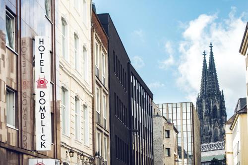 a city street with buildings and a church at Hotel Domblick Garni in Cologne