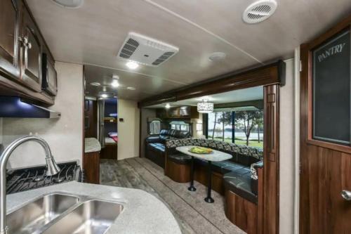 an rv kitchen and living room with a bar at Heartland North Trail 31' RV in Manchaca