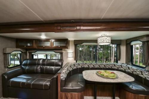 a living room in an rv with a couch and a table at Heartland North Trail 31' RV in Manchaca