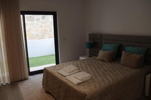 a bedroom with a bed with two towels on it at Sweet Home in Painzela