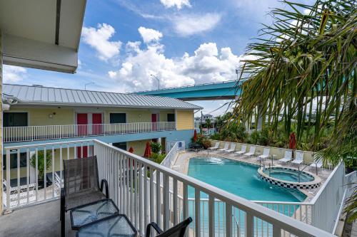 a balcony of a resort with a swimming pool at Harbour House at the Inn 313 in Fort Myers Beach