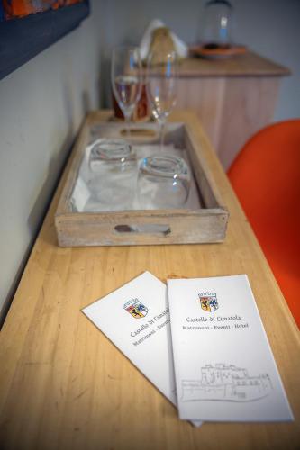 a wooden table with a tray with glasses on it at Castello di Limatola in Limatola