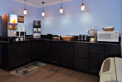 a kitchen with a counter top with a microwave at Americas Best Value Inn Hollywood in Los Angeles