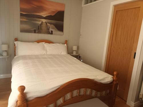 a bedroom with a bed with a picture on the wall at Kate's Place bedroom ensuite close to Donegal town in Murlas Bridge