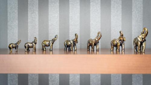 a group of bronze horses on a wooden shelf at Videviku Villa Apartments in Tallinn