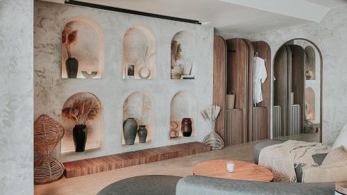a room with a wall with vases on it at The Cara Boutique Hotel in Kota Kinabalu