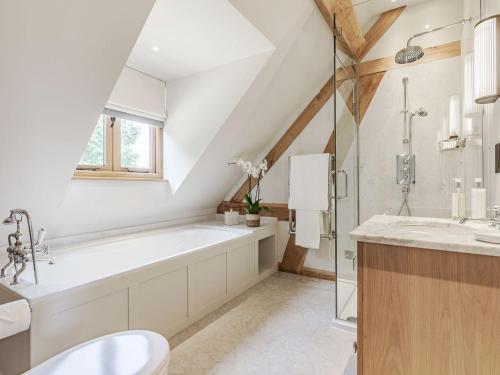 a bathroom with a large tub and a sink at Lovington Barn in Ovington