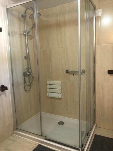 a shower with a glass door in a bathroom at Casa Lerryn in Sertã
