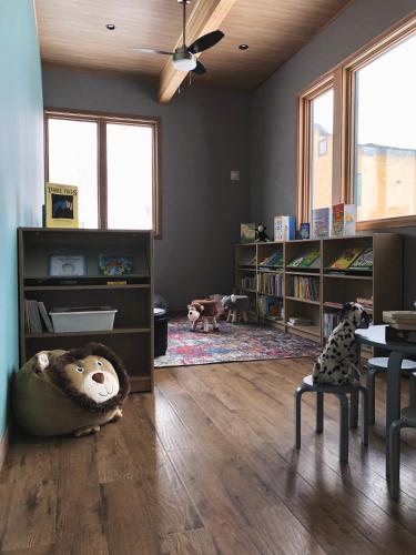 a living room with a stuffed bear on the floor at Hakobune Niseko - 8-room Chalets & 2-room Apartments in Niseko