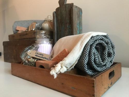 a wooden box with items in it on a table at AuxiliumWellness Get Back to Serenity in Grobbendonk