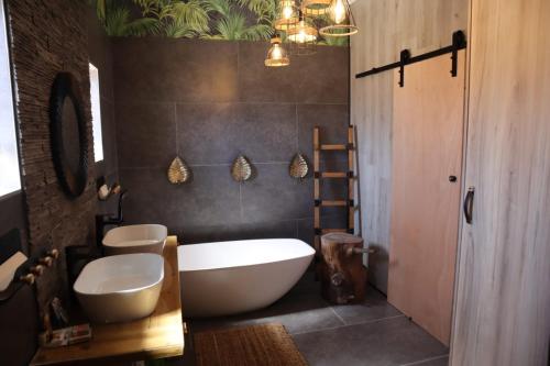 a bathroom with a tub and a toilet and a sink at Villa Grande Luxury accommodation in Welkom