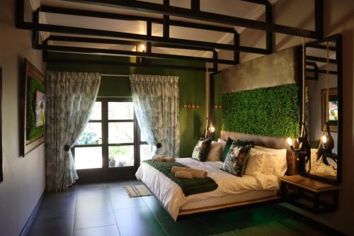 a bedroom with a large bed and a window at Villa Grande Luxury accommodation in Welkom