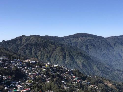 a view of a town in the mountains at MAMTA HOMESTAY in Darjeeling
