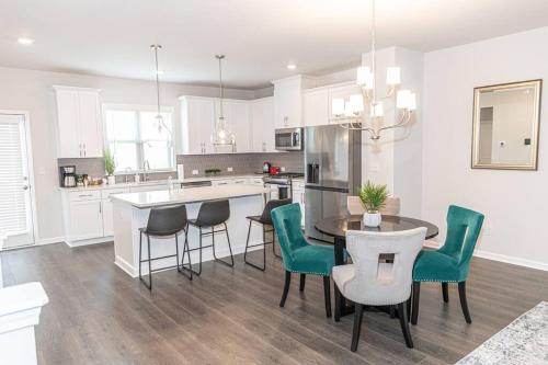 a kitchen with a table and chairs and a counter at New spacious 3 bedroom suite garage parking free Wi-Fi office space and patio view in Duluth
